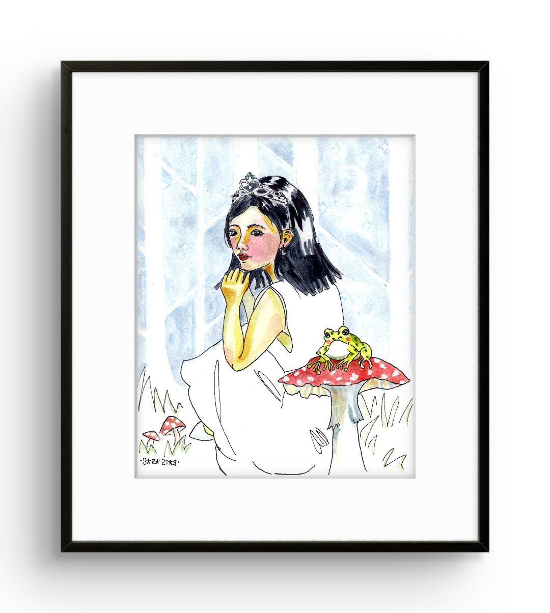 A framed art print featuring a whimsical watercolor illustration of a girl in a white dress beside a red mushroom with a green frog, displayed against a clean white background.